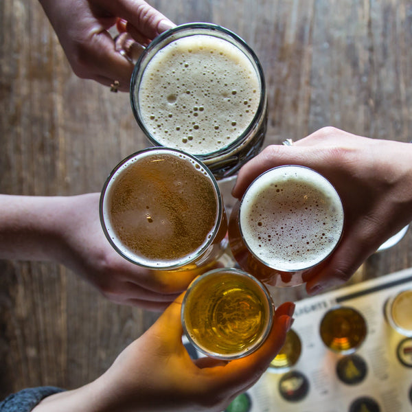 Four people toast with beer at Amsterdam Brewhouse restaurant